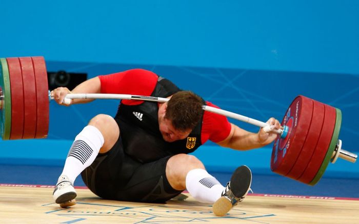 Germany's Matthias Steiner is injured while his weights fall during the men's +105kg Group A snatch weightlifting competition during the London 2012 Olympic Games...Germany's Matthias Steiner is injured while his weights fall during the men's +105kg Group A snatch weightlifting competition at the ExCel venue during the London 2012 Olympic Games August 7, 2012. REUTERS/Grigory Dukor (BRITAIN - Tags: OLYMPICS SPORT WEIGHTLIFTING TPX IMAGES OF THE DAY)