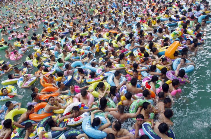 ATTENTION EDITORS - 6 OF 21 PICTURES TO MATCH PACKAGE 'WORLD POPULATION - SEVEN BILLION' - TO FIND ALL PICTURES SEARCH 'POPULATION-BABY/' Residents crowd in a swimming pool to escape the summer heat during a hot weather spell in Daying county of Suining, Sichuan province in this file picture taken July 4, 2010. The world?s population will reach seven billion on 31 October 2011, according to projections by the United Nations, which says this global milestone presents both an opportunity and a challenge for the planet. While more people are living longer and healthier lives, says the U.N., gaps between rich and poor are widening and more people than ever are vulnerable to food insecurity and water shortages. REUTERS/Stringer/Files (CHINA - Tags: SOCIETY ENVIRONMENT IMAGES OF THE DAY) CHINA OUT. NO COMMERCIAL OR EDITORIAL SALES IN CHINA