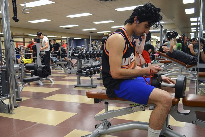 SAIT student takes a break from his workout and takes a looks at his phone at the SAIT gym at SAIT Polytechnic in Calgary on Monday, Jan. 13, 2014. The SAIT gym underwent small renovations throughout the summer and first semester of the 2013 school year. (Photo by Husson Zaman/The Press)